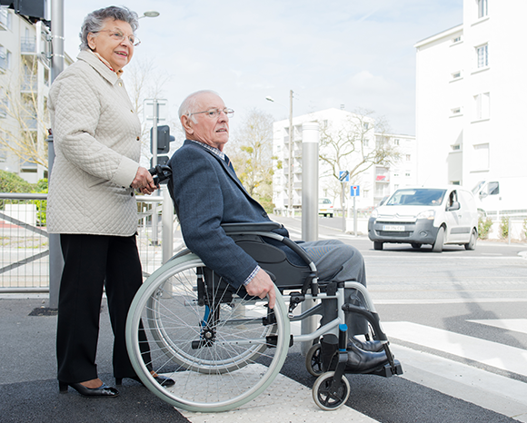 image of elderly couple crossing street