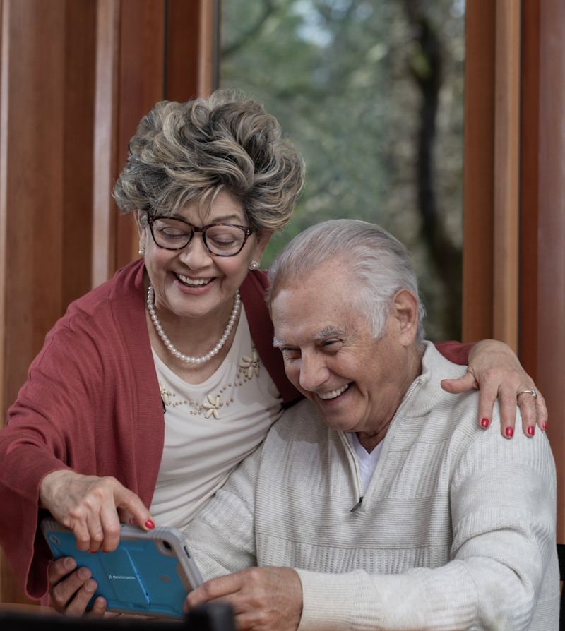 two seniors looking at a tablet