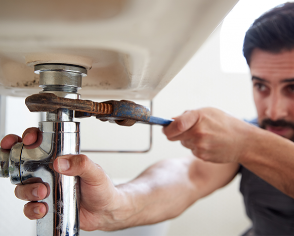 Man working on sink